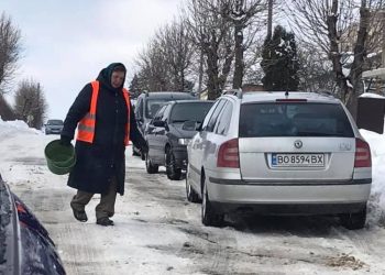 Зекономили: у місті на Тернопільщині замість техніки на дорогу випустили жіночку з відром піску (Фото)